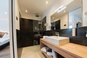 a bathroom with a sink and a mirror at Hotel Gran Pre in San Vigilio Di Marebbe