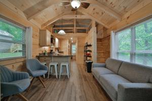 una sala de estar y cocina en una casa pequeña en Lena Cabin Wooded Tiny Cabin - Hot Tub, en Chattanooga