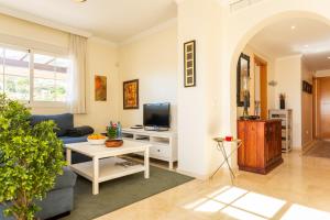 a living room with a couch and a tv at Penthouse Apartment in Benalmadena in Benalmádena