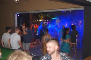 a group of people dancing in a room with blue lights at Camping la Rouvière in Chame