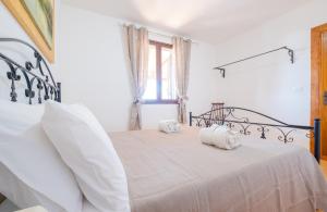 Postelja oz. postelje v sobi nastanitve Villa Giulia con Piscina Privata - Specchia