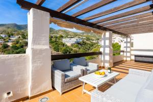 a balcony with a table and chairs and a view at Penthouse Apartment in Benalmadena in Benalmádena