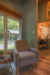 a living room with a chair and a table at Lookout Tiny Cabin 5 Min To Downtown Chattanooga in Chattanooga