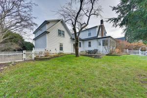 a white house with a tree in the yard at Home with Backyard about 2 Mi to Downtown Lexington! in Lexington