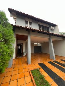 a house with an orange tile floor and a building at Pousada cravo & canela in Maringá