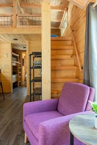 a purple couch in a room with a wooden wall at Luke Cabin Escape To Our Luxury Hot Tub Cabin in Chattanooga