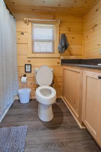a bathroom with a toilet in a wooden cabin at Luke Cabin Escape To Our Luxury Hot Tub Cabin in Chattanooga