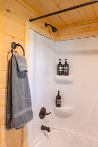 a bathroom with a shower with a towel and a sink at Luke Cabin Escape To Our Luxury Hot Tub Cabin in Chattanooga
