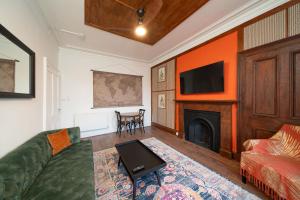 a living room with a couch and a fireplace at Central Apartments - Colonial in Blairgowrie