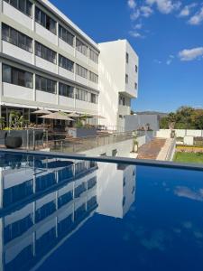 ein Hotel mit einem Pool vor einem Gebäude in der Unterkunft Hotel Cinco Diamantes in Atotonilco el Alto