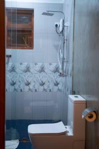 a bathroom with a toilet and a shower at Style Villa in Bentota