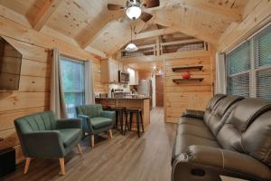 a living room with a couch and chairs and a kitchen at Martha Cabin Tiny Cabin By Downtown Chattanooga in Chattanooga
