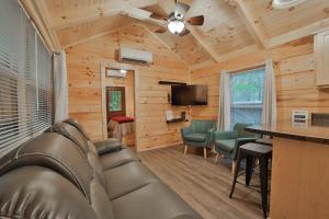 a living room with a couch and a flat screen tv at Martha Cabin Tiny Cabin By Downtown Chattanooga in Chattanooga