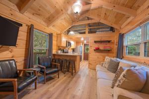 a living room and kitchen of a tiny house at Peggers Cabin Luxury Rustic Tiny Cabin Spa in Chattanooga