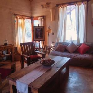 a living room with a table and a couch at La Calandria in Los Hornillos