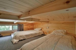 Un pat sau paturi într-o cameră la River Cabin Hot Tub & Swim Spa Near Downtown