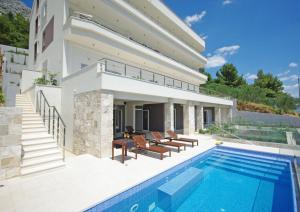 a villa with a swimming pool and a house at Villa Jolara With Pool - Deluxe Suite 13 in Mimice