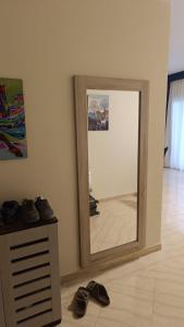 a mirror in a room with shoes on the floor at Hurghada apartment in Hurghada