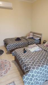 two beds in a room with two mattresses at Hurghada apartment in Hurghada