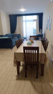 a living room with a table and chairs and a couch at Hurghada apartment in Hurghada