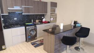 a kitchen with a stove and a washing machine at Hurghada apartment in Hurghada