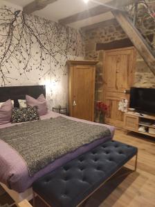 une chambre avec un lit et une télévision dans l'établissement La Ville Es Riez Chambre d'hôtes, à Corseul