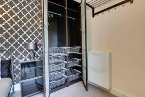 a room with a closet with shelves and a refrigerator at Modern Studio Apartment - Vibrant Abbeydale Rd, FREE Parking, Pet Friendly, Netflix in Sheffield