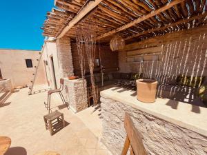 an outdoor patio with a stove and a couch at Yogam villa Essaouira in Al Ghar