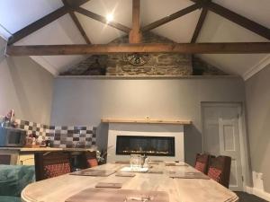 a dining room with a table and a fireplace at Central House in Shillelagh