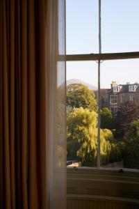 a window with a view of trees and buildings at Marine North Berwick in North Berwick