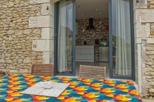 a table with a colorful table cloth on a patio at L'atelier in Chambourg-sur-Indre