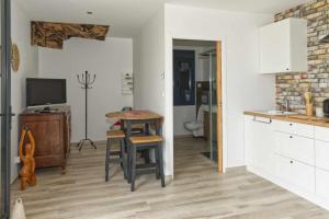 a kitchen with a table and a stool and a table at L'atelier in Chambourg-sur-Indre
