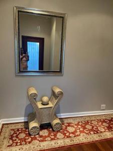 a man taking a picture of a mirror in a room at Fun-filled, cosy family home in Gqeberha