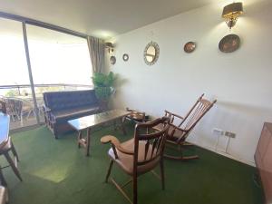 a living room with chairs and a table and a couch at Departamento excelente ubicación frente a playa in Viña del Mar