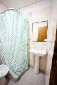 a bathroom with a sink and a shower at LEAD Pods Hostel in Salta