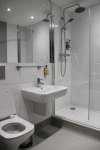 a bathroom with a toilet and a sink and a shower at Blue Boar Hotel in Maldon