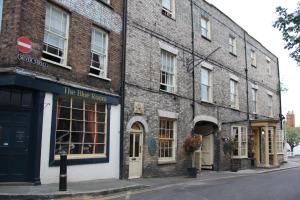 a brick building with a blue room on a street at Blue Boar Hotel in Maldon