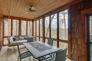a screened in porch with a table and chairs at Lakefront Custom-Built Mentone Home Game Room! in Mentone
