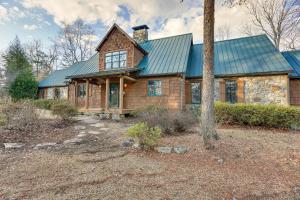 a wooden house with a green roof at Lakefront Custom-Built Mentone Home Game Room! in Mentone