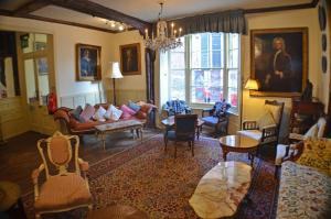 a living room filled with furniture and a chandelier at Blue Boar Hotel in Maldon