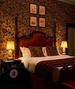 a bedroom with a large bed with two lamps at Marine North Berwick in North Berwick