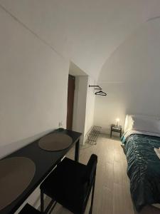 a bedroom with a bed and a table and chairs at Casa Baglioni in Naples