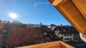 a view from the porch of a house with a roof at LIBORIA I Traumhafte Ferienwohnung in Aidling am Riegsee mit atemberaubendem Blick auf die majestätische Zugspitze! in Riegsee
