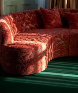 a red couch sitting in a living room at Marine North Berwick in North Berwick