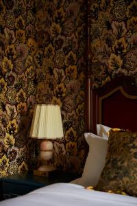 a lamp sitting on a table next to a bed at Marine North Berwick in North Berwick