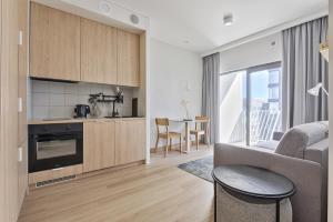 a kitchen and living room with a couch and a table at Noli Mokotow in Warsaw