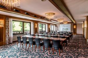 uma sala de jantar com uma mesa longa e cadeiras em Sauerland Alpin Hotel em Schmallenberg