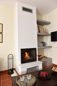 a living room with a fireplace in the wall at Alkinoe Suite Arachova in Arachova
