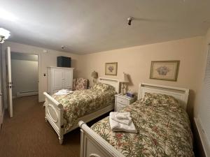 a hotel room with two beds in a room at The Oaks B&B Hotel and Spiritual Center in Jamestown +67 photos