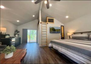 a bedroom with a bed and a staircase in it at Loft Cabin 2 - Rogue River Resort in Grants Pass